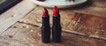 Two Red Lipsticks on Wooden Table Royalty Free Stock Photo