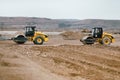 Two Vibratory Soil Compactors during road and highway construction. Industrial roadworks with heavy-duty machinery in construction