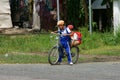 Two Vietnamese little boy riding bike go to school