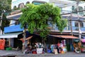 Two Vietnamese man at outdoor tailor shop, fix clothes with sewing machine Royalty Free Stock Photo