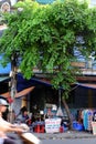 Two Vietnamese man at outdoor tailor shop, fix clothes with sewing machine Royalty Free Stock Photo