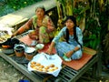 Two Vietnamese woman selling cakes in village