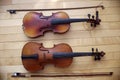 Antique string violins on wood floor background Royalty Free Stock Photo