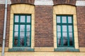 Two vintage design green windows on the brick facade of the old Royalty Free Stock Photo