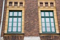 Two vintage design green windows on the brick facade of the old Royalty Free Stock Photo