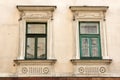 Two vintage design green windows on the facade of the old house Royalty Free Stock Photo