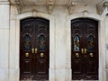 Two vintage double doors decorated with classy art deco ornate outside on the street of Elvas, Portugal Royalty Free Stock Photo