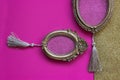 Two vintage golden oval picture frames on pink and golden background, with copy space in the frame Royalty Free Stock Photo