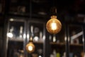 Two vintage incandescent lamps in a dark space on the background of an antique cabinet