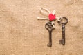 Two vintage key and a red heart on old cloth Royalty Free Stock Photo