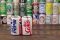 A row of vintage Pepsi, Coca-Cola aluminium cans with the cans background located on the wooden table