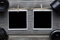 Two vintage photo frames with empty space and old lenses on wooden table Royalty Free Stock Photo