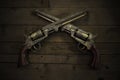 Two vintage pistols on wooden background Royalty Free Stock Photo