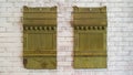 Two vintage tin awning panels on a wall in Montana