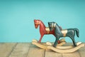 Two vintage rocking horse on wooden floor. Blue and red Royalty Free Stock Photo