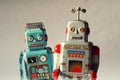 Two vintage tin toy robots, robotic delivery, artificial intelligence concept Royalty Free Stock Photo