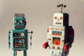 Two vintage tin toy robots, robotic delivery, artificial intelligence concept