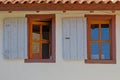 Two vintage wooden windows on pale white wall Royalty Free Stock Photo