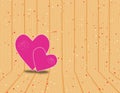 Two violet hearts on wooden background