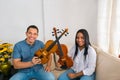 Two violinists posing with their violins. Close up portrait