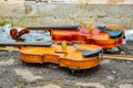 Two violins lie on the asphalt next to the snow Royalty Free Stock Photo