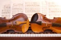 Two violins on piano keys Royalty Free Stock Photo