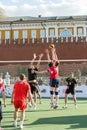 Two volleyball players try to block the ball