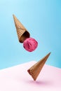 Two waffle cones and a scoop of ice cream on a pink and blue background Royalty Free Stock Photo