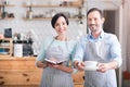 Two waiters in aprons standing in cafe Royalty Free Stock Photo