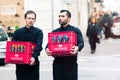 Two waiters carrying the crates of wine in the historic center of Rome, Italy.