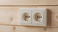 Two wall sockets installed on a wooden panel in a modern interior space for electrical connectivity and usage Royalty Free Stock Photo