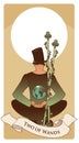 Two of wands. Tarot cards. Young man sitting, wearing hat looking at a globe