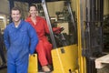 Two warehouse workers with forklift Royalty Free Stock Photo