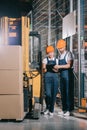 Two warehouse workers looking at clipboard Royalty Free Stock Photo