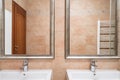 Two washbasins in beige toilet