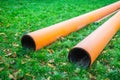 Two water pipes on grass during plumbing repairs under construction Royalty Free Stock Photo