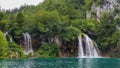 Two waterfalls flowing into a lake at Plitvice Lakes, UNESCO World Heritage Site Royalty Free Stock Photo