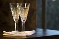 Two Waterford Champagne Glasses on Wooden Table