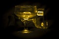 The two waterglass with yellow magic lights. Royalty Free Stock Photo