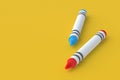 Two wax crayons on yellow background. Colorful pencils. Back to school concept