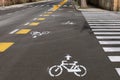 Two way bike lane along the urban street with painted signs, directiona arrows and crosswalks Royalty Free Stock Photo