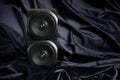 Two-way speaker in an interior decorated with dark natural silk. Softening the sound of an audio system. Audio broadcasting and Royalty Free Stock Photo