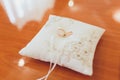 Two wedding gold rings lying on silk lace cushion for rings. Wedding accessories bride and groom before the ceremony Royalty Free Stock Photo