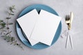 Two Wedding invitation card mockup 5x7 on grey background with eucalyptus, Menu card mockup with table setting Royalty Free Stock Photo