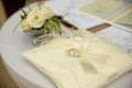 Two wedding platinum rings lying on silk lace cushion for rings