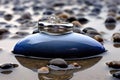 two wedding rings in a blue mussel shell on a bed of polished beach pebbles Royalty Free Stock Photo