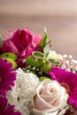 Two wedding rings on flowers of a bridal colorful bouquet Royalty Free Stock Photo