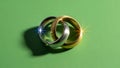 Two Wedding Rings on Green Background Royalty Free Stock Photo