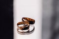 Two wedding rings laying on flat mirror