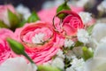 Two wedding rings and pink and white roses Royalty Free Stock Photo